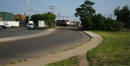 FIGURE 20. Street Name Changes from Carter Street to Third Street at Curve in Road
Figure 20 shows a commuter rail train crossing Third Street a short distance from where Carter Street becomes Third Street.